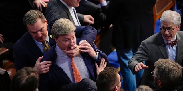 Rep. Richard Hudson, R-N.C., left, pulls Rep. Mike Rogers, R-Ala., back as they talk with Rep. Matt Gaetz, R-Fla., and other during the 14th round of voting for speaker as the House meets for the fourth day to try and elect a speaker and convene the 118th Congress in Washington, Friday, Jan. 6, 2023. 