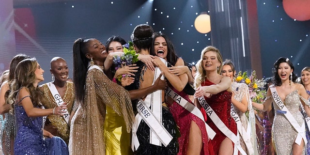 Miss USA R'Bonney Gabriel, back to camera, is hugged by other contestants after being crowned Miss Universe at the 71st Miss Universe pageant, in New Orleans on Saturday, Jan. 14, 2023. 