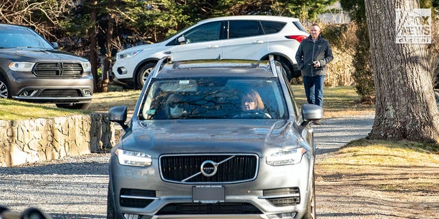 The car with the Walshe children is seen driving away from the family's home on Chief Justice Cushing Highway, Cohasset, Massachusetts, Sunday. 