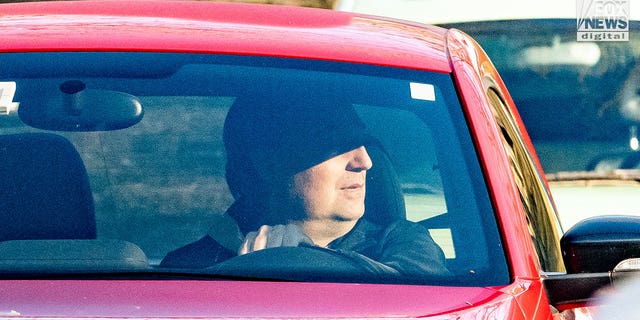 A man who appears to be Brian Walshe is seen driving away from Walshe home on Chief Justice Cushing Highway, Cohasset, Massachusetts, Sunday. Law enforcement appears to have moved family out of house to investigate contents.