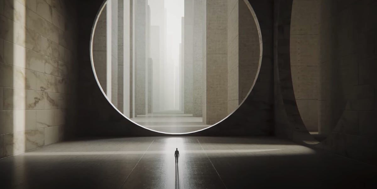 A tiny man walks toward a giant circle opening, with a city in the distance