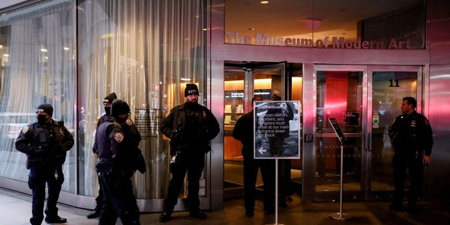 Members of the New York City Police Department (NYPD) gather at the entrance of the Museum of Modern Art (MOMA) after a multiple stabbing incident, in New York, U.S., March 12, 2022.