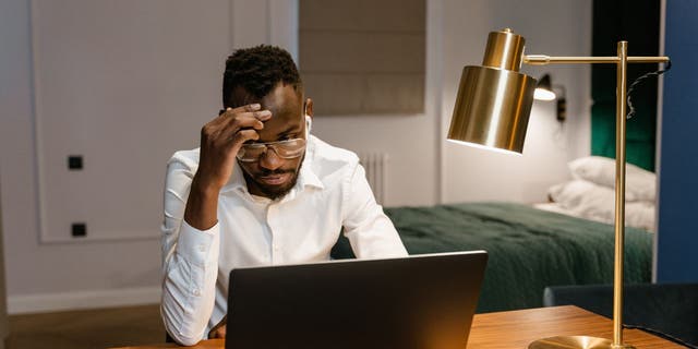 Man stressed on laptop