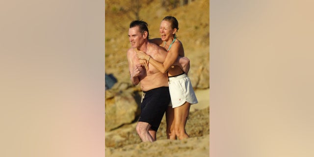 Naomi Watts holds on tight to her boyfriend Billy Crudup on the beach.