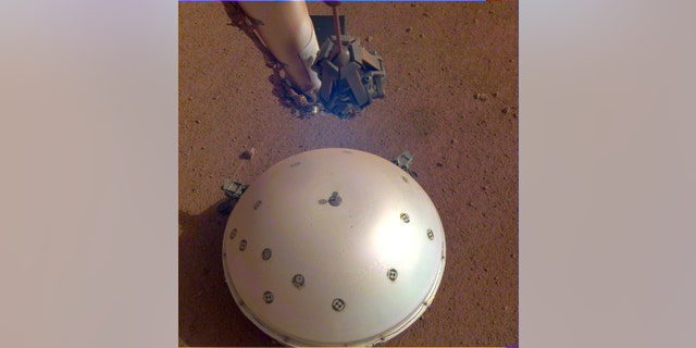 This image shows InSight’s domed Wind and Thermal Shield, which covers its seismometer, called Seismic Experiment for Interior Structure, or SEIS.