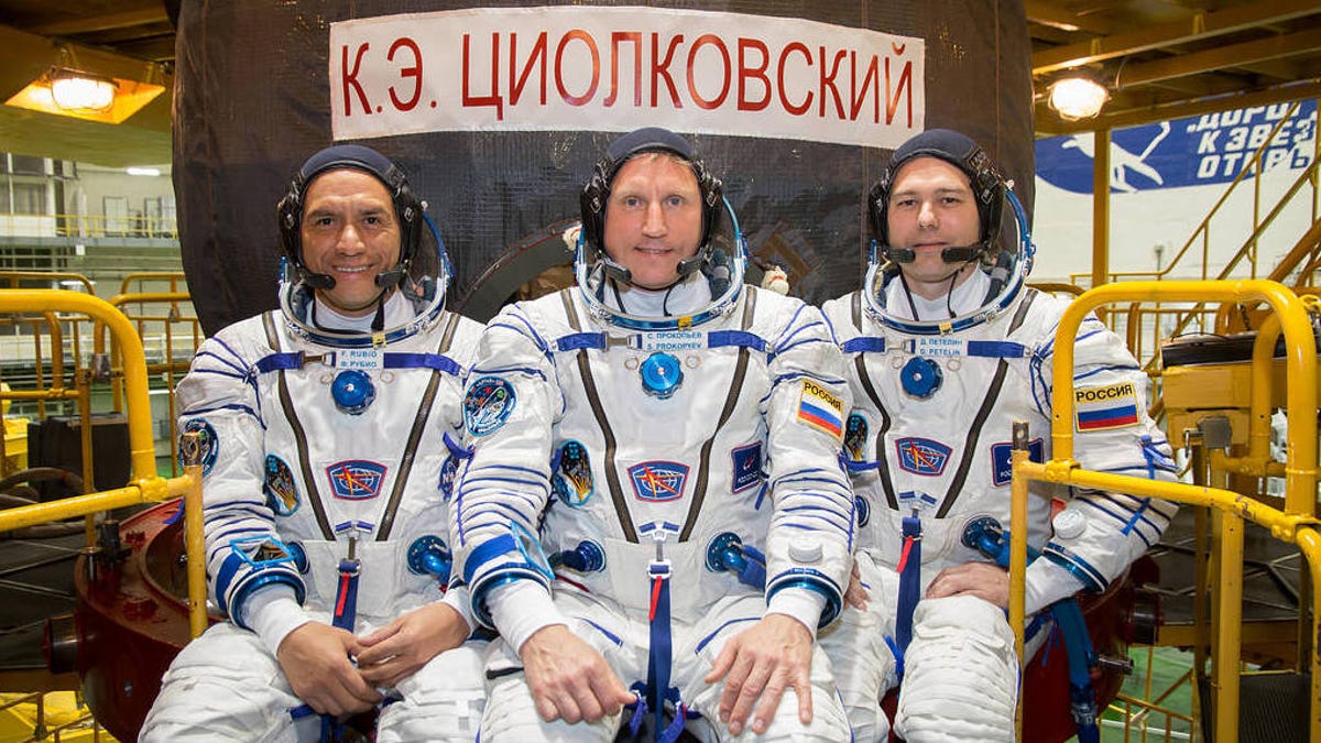 NASA astronaut Frank Rubio (left), Roscosmos cosmonaut Sergey Prokopyev (center) and Roscosmos cosmonaut Dmitri Petelin (right) sit together in their flight suits in Kazakhstan.