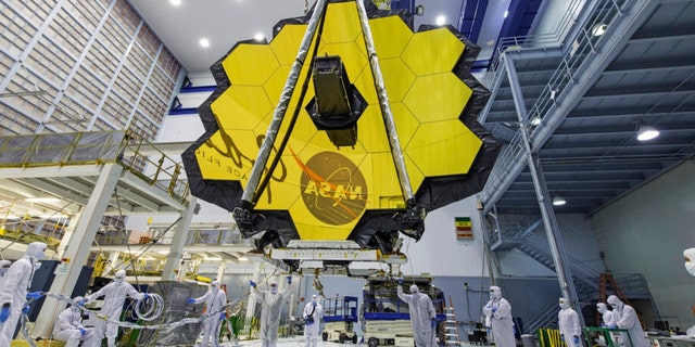 FILE - In this April 13, 2017, photo provided by NASA, technicians lift the mirror of the James Webb Space Telescope using a crane at the Goddard Space Flight Center in Greenbelt, Maryland.