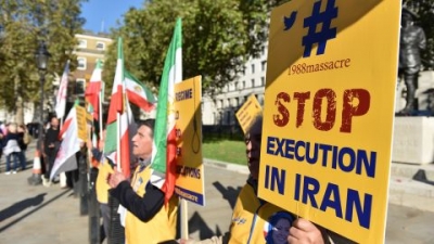 People protest against Iran's death penalty opposite Downing Street as a march to demand a people's vote against Brexit passes by on October 2018 in London, England. 