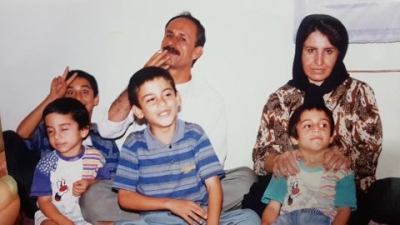 Navid Afkari (bottom left), sitting with his brother Vahid (top left), brother Saeid (bottom center), Habib (bottom right) father (top center) and mother (top right). 
