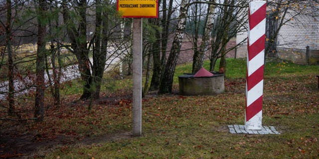 A sign with the words 'State border crossing prohibited' is seen near the three country border point, where the borders of Lithuania, Poland and the Russian exclave of Kaliningrad intersect near Zerdziny, Poland on 10 November, 2022. 