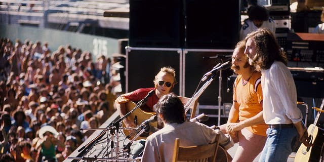 (L-R) Stephen Stills, Neil Young, David Crosby and Graham Nash of Crosby Stills Nash And Young perform on stage at Oakland Coliseum on 13th July 1974 in Oakland, Calif.