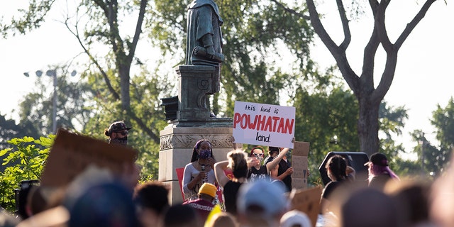 Protesters surround a statue of Christopher Columbus before marching, eventually returning and pulling it down in Richmond, Virginia, June 9, 2020. 