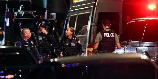 Law enforcement personnel gather at the scene where authorities reported two Newark police officers were shot on Nov. 1, 2022. On Thursday, two Newark officers were stabbed during a domestic violence response call, authorities said. 