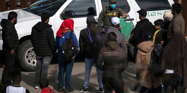 A border patrol agent communicates with illegal immigrants after they entered the U.S. near Tijuana, Mexico in November. A Border Patrol agent in New Mexico was shot multiple times in the chest Thursday but survived.