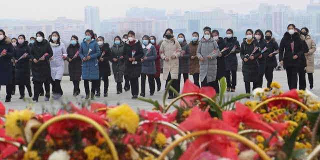 North Koreans visit the statues of late leaders Kim Il Sung and Kim Jong Il in Pyongyang, North Korea, on, Jan. 22, 2023. Russia’s embassy in North Korea says the country has eased epidemic controls that were placed to slow the spread of respiratory illnesses. 