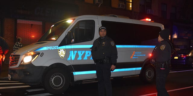 Police officers stand guard on a road after a 19-year-old assailant attacked three NYPD officers with a machete near Times Square during the New Year's Eve celebrations on Dec. 31, 2022.