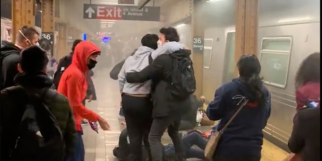 A person is helped outside a subway car in Brooklyn on April 12, 2022, in New York City.