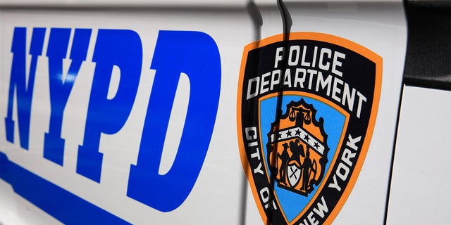 An NYPD logo on a police patrol car.