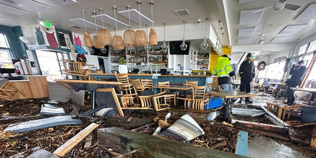 A support piece from the Capitola Wharf is seen inside the storm damaged Zelda's restaurant in Capitola, Calif., on Jan. 5, 2023.