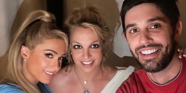 Fans took to Paris Hilton's comment section on Instagram to voice their concerns about the authenticity of this picture with Hilton, Britney Spears and Cade Hudson. Several users called attention to how Spears' necklaces appeared.