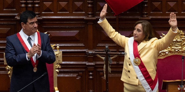 Peruvian Dina Boluarte, right, greets members of the Congress after being sworn in as the new president hours after former President Pedro Castillo was impeached in Lima, on Dec. 7, 2022. 