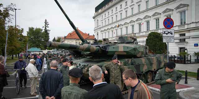A Leopard 2 tank of the Polish Army is seen with a soldier in camouflage near Pilsudski Square in Warsaw, Poland, on Sept 13, 2022. Leaders in Poland are set to discuss the request by Poland to send tanks to Ukraine as the war between Russia and Ukraine continues.
