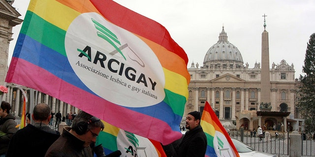 Italian Arcigay gay rights association activists hold banners and flags during a demonstration in front of The Vatican, Tuesday, Jan. 13, 2009. 