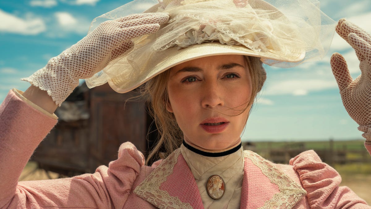 Close up of Emily Blunt as Cornelia Locke, wearing a pink dress out in the desert.