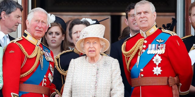 Prince Charles, Queen Elizabeth II and Prince Andrew watch a flypast from the balcony of Buckingham Palace during Trooping The Colour, the Queen's annual birthday parade, June 8, 2019, in London.