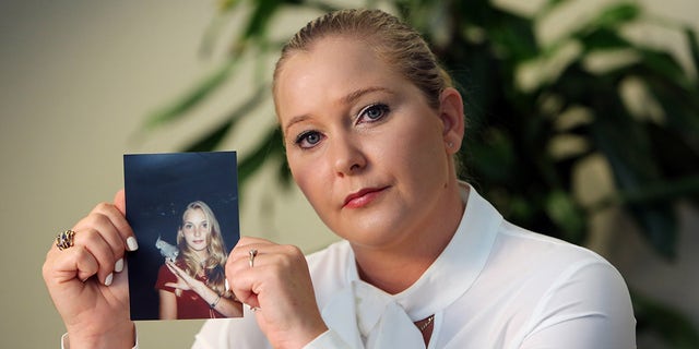 Virginia Giuffre holds a photo of herself at age 16, when she said Palm Beach multimillionaire Jeffrey Epstein began abusing her sexually.