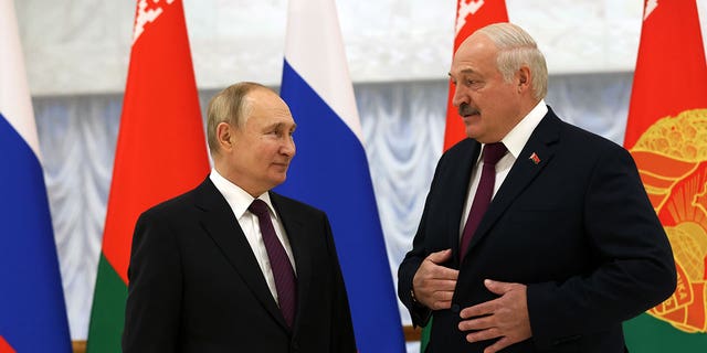Russian President Vladimir Putin, left, and Belarussian President Alexander Lukashenko, right, are seen during the welcoming ceremony on Dec. 19, 2022, in Minsk, Belarus. 