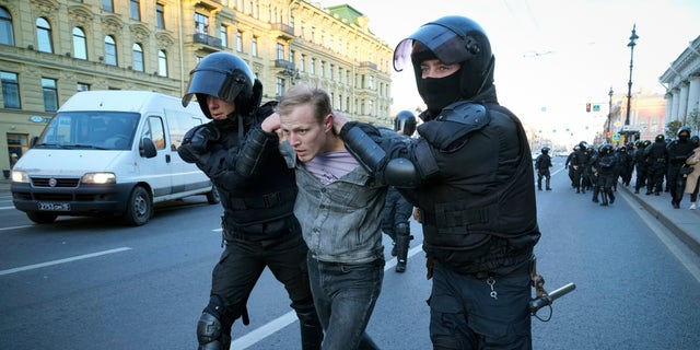 Russian policemen detain a demonstrator protesting against mobilization in St. Petersburg, Russia, Saturday, Sept. 24, 2022.