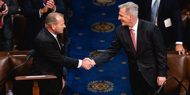 Representative Kevin McCarthy, a Republican from California, right, shakes hands with Representative Troy Nehls, a Republican from Texas, while nominating McCarthy to be the next Speaker of the House during a meeting of the 118th Congress in the House Chamber at the US Capitol in Washington, DC, US, on Thursday, Jan. 5, 2023.