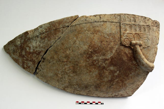 Rounded fragments of a marble wash basin used in ancient Greek rituals.