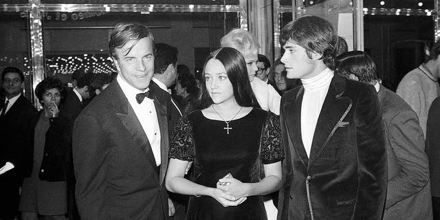 FILE - "Romeo and Juliette" movie director Franco Zeffirelli, left, actors Olivia Hussey, center, and Leonard Whiting are seen after the Parisian premiere of the film in Paris on Sept. 25, 1968. The two stars of 1968's "Romeo and Juliet" sued Paramount Pictures for more than $500 million on Tuesday, Jan. 3, 2023, over a nude scene in the film shot when they were teens.