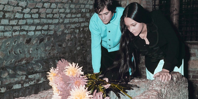 FILE - Olivia Hussey and Leonard Whiting, who are playing the title roles in Franco Zeffirelli's "Romeo and Juliet," place flowers on the "Tomba di Giulietta," or the Tomb of Juliet, in Verona, northern Italy, on Oct. 22, 1968. 