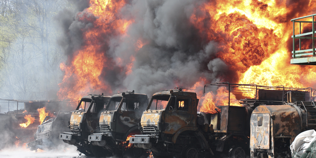Vehicles are seen in flames at an oil depot after missiles struck the facility in an area controlled by Russian-backed separatist forces in Makiivka, eastern Ukraine, on Wednesday, May 4, 2022.