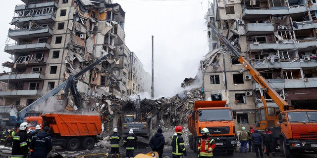 Emergency personnel work at the site where an apartment block was heavily damaged by a Russian missile strike in Dnipro, Ukraine on January 15, 2023. 