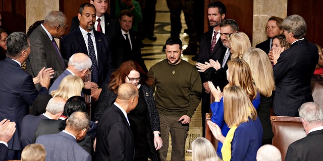Ukranian President Volodymyr Zelenskyy, center, arrives to speak during a joint meeting of Congress at the U.S. Capitol on Dec. 21, 2022.