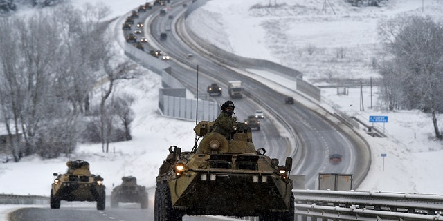 A convoy of Russian armored vehicles moves along a highway in Crimea.