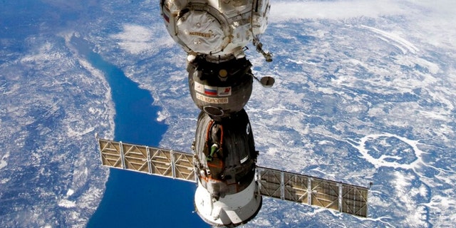 This undated handout photo taken by Russian cosmonaut Sergei Korsakov and released by Roscosmos State Space Corporation shows a Soyuz capsule of the International Space Station (ISS) during its fly.