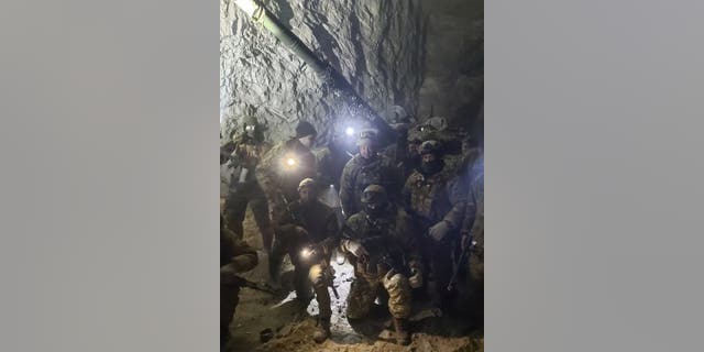 People in military uniform, claimed to be soldiers of the Russian mercenary group Wagner and its head Yevgeny Prigozhin, pose for a picture believed to be in a salt mine in Soledar in the Donetsk region, Ukraine, in this handout picture released Jan. 10, 2023. 