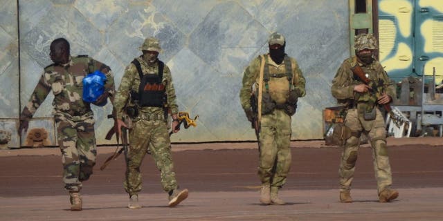 This undated photograph handed out by the French military shows three Russian mercenaries, right, in northern Mali.