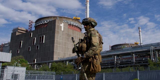 A Russian serviceman patrols the territory of the Zaporizhzhia Nuclear Power Station in Energodar on May 1, 2022. 