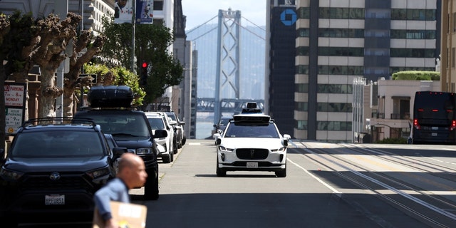 A Waymo autonomous vehicle drives along California Street on April 11, 2022, in San Francisco, California. 