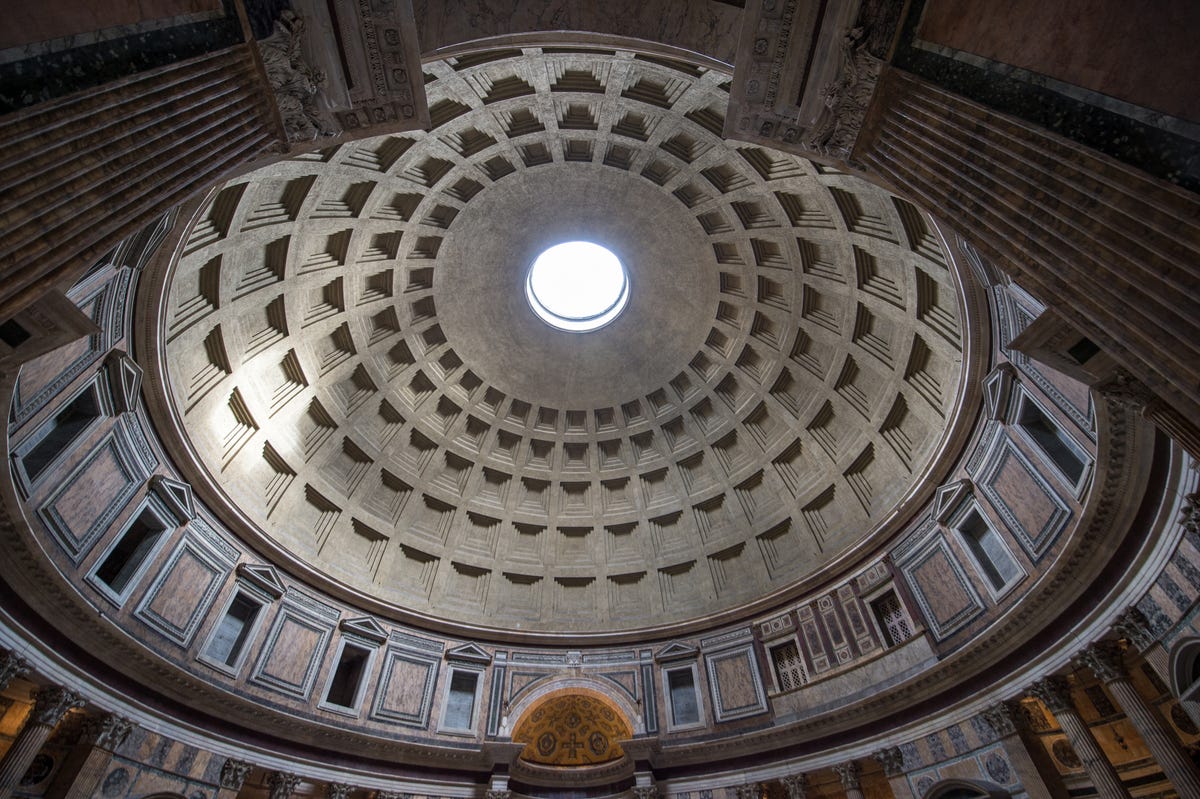 A view inside Rome's Pantheon shows a decorative dome. You're looking up at it from a low angle.
