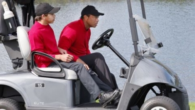 Tiger and Charlie Woods share a cart Sunday.