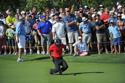 Woods falls to the ground in pain after hitting a shot at The Barclays in August 2013. A few months later, he would undergo back surgery for a pinched nerve.