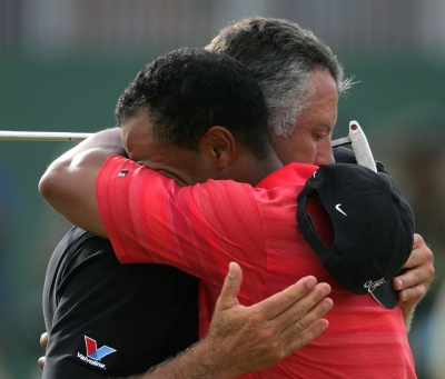 Woods hugs Williams after winning the British Open in Hoylake, England in 2006. It was Woods' first major win since the death of his father just a couple of months earlier.