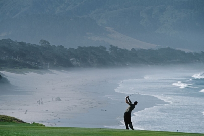Woods plays a shot from the ninth fairway during the 2000 US Open in Pebble Beach, California. Woods won the tournament by 15 shots, a record for any major. It was Woods' third major title by this point; he had also won the 1999 PGA Championship.